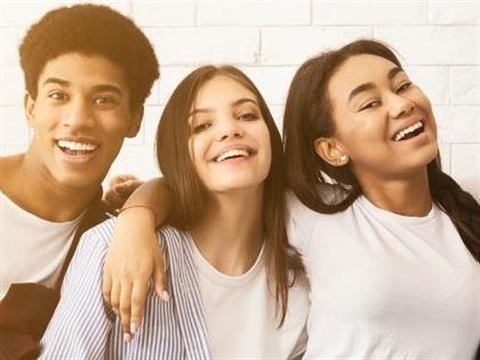 three young adults smiling 