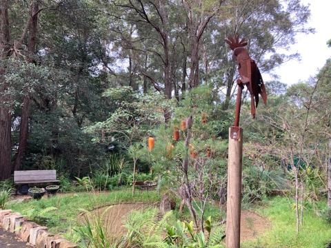 Garden with native plants and bird sculpture