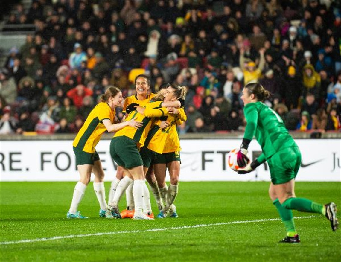 Matildas players celebrate after scoring a goal