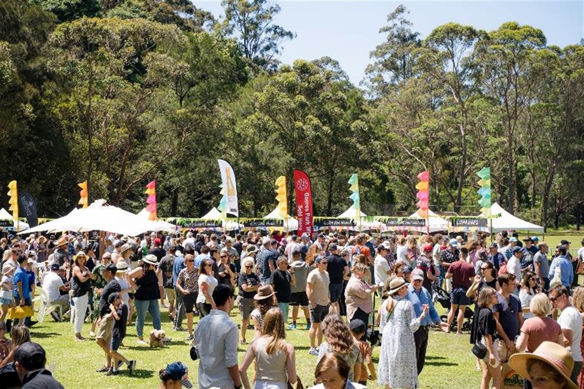 A large crowd of people enjoying Food and Wine by the River in 2022.