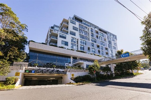 The apartment block at 1-5 Pottery Lane looking from Synergy Youth Centre. You can see the car park entrance and the pedestrian bridge.