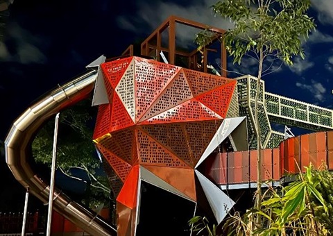 The first playground tower at Wadanggari Park. The playground resembles a banksia and is set against the night sky.