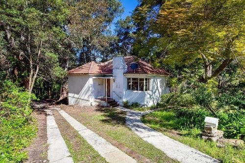 A white house and driveway surrounded by bushland at 14 Gay Street, Lane Cove