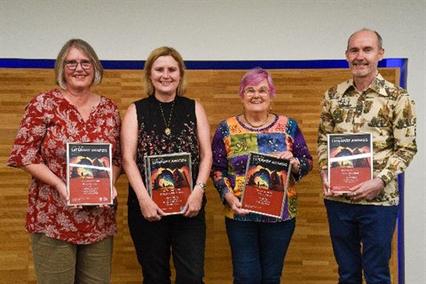 Four winners of the 2023 Lane Cove Literary Awards stand next to each other holding their certificates.