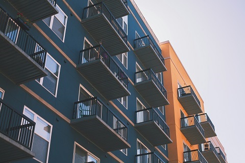 A low angle shot of two apartment blocks next to each other.