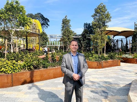Major Zbik stands in front of the yellow banksia playground unit at Wadanggari Park